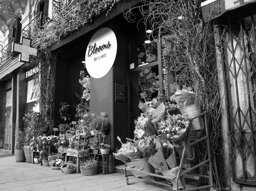 The storefront of Bloomst, a florist shop on Woodside High Street, displays an array of fresh floral arrangements and bouquets outside the shop entrance. The arrangement includes a variety of flowers