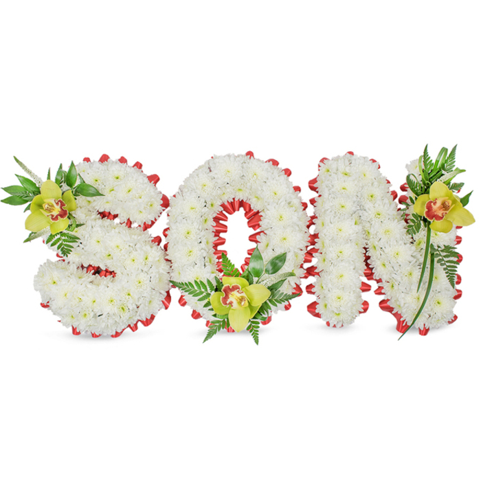 A meticulously made sympathy tribute spells SON in bold, three-dimensional block letters, each letter composed of thick clusters of immaculate white chrysanthemum blossoms that give the words a soft, sculpted presence. The edges of the letters are defined by a continuous hand-pleated red ribbon that forms a neat, scalloped frame around each shape and draws the eye into the hollow centre of the O. The design is punctuated by three lime-green Cymbidium orchids-one set into the upper left curve of the S, one sitting low within the O's opening, and the third placed on the upper right of the N-their pale yellow-green petals contrasted by delicate reddish-brown markings in each throat. Around these orchid accents, a rich sweep of glossy leaves and fine fern fronds creates natural volume and a subtle vertical lift, while the chrysanthemums' dense petals maintain a calm, uniform texture. The composition balances purity and warmth: the white suggests reverence, the red ribbon implies love and remembrance, and the orchids introduce a refined, living focal point. Under gentle, diffuse lighting the arrangement's surfaces-the matt chrysanthemum blooms, the satin ribbon, and the waxy orchid petals-are clearly legible and inviting to the touch in the imagination. Created for funerals, memorial services, and graveside honourings, this piece is particularly suited to families in Woodside and neighbouring streets or parks seeking a personalised tribute; its craftsmanship reflects traditional sympathy floristry executed with careful intention and quiet respect.